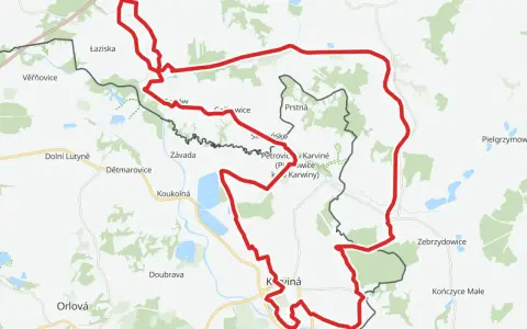 Mapa z zaznaczonym czerwonym szlakiem rowerowym, biegnącym przez tereny z nazwami miejscowości jak Łaziska, Petrovice, Karviná i Jastrzębie-Zdrój.