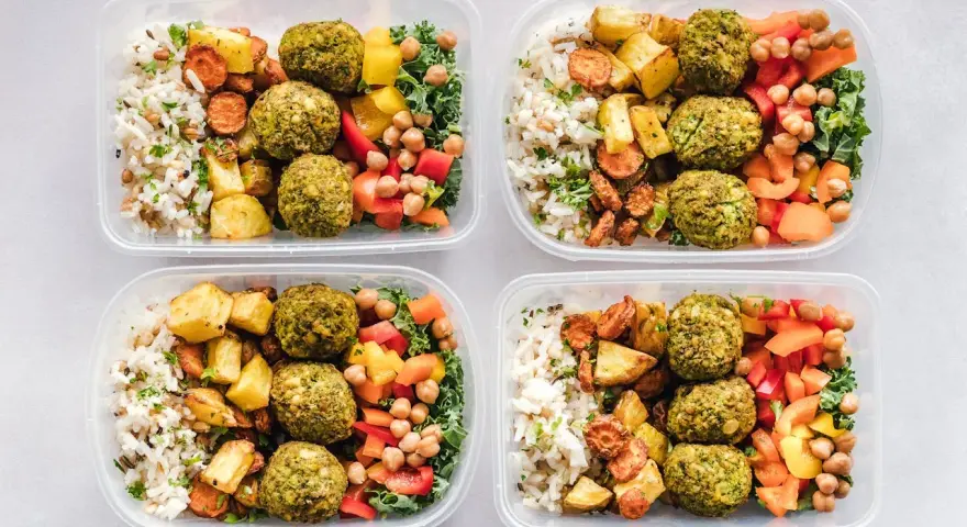 Cztery pojemniki z posiłkami: ryż, pieczone ziemniaki, marchewka, falafel, ciecierzyca i warzywa. Idealne na dietę 3000 kcal.