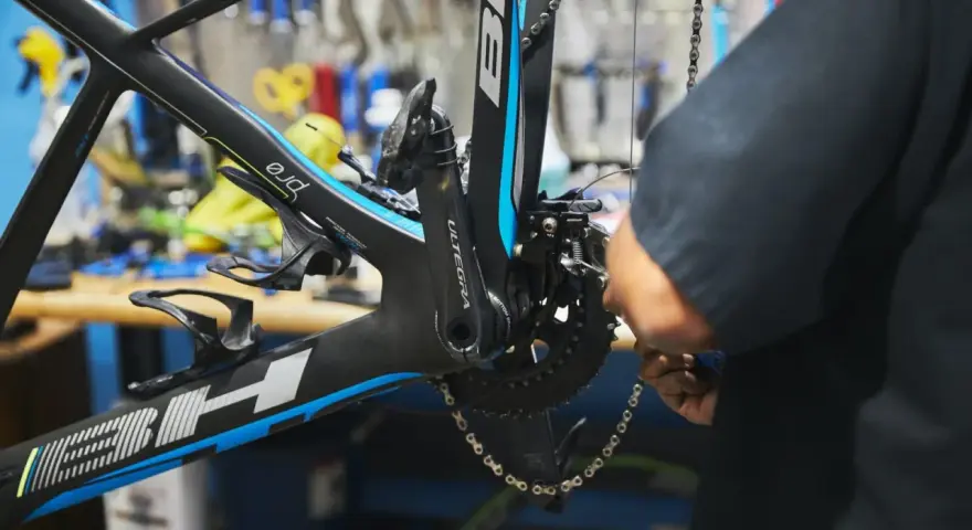 Mechanik dokonuje regulacji przedniej przerzutki w rowerze szosowym BH.