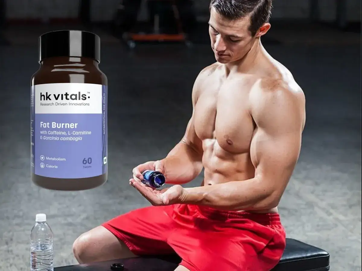 Mężczyzna z wyrzeźbioną sylwetką trzyma suplement Fat Burner. To może być część jego strategii, by osiągnąć szczyt w rankingu spalaczy tłuszczu.